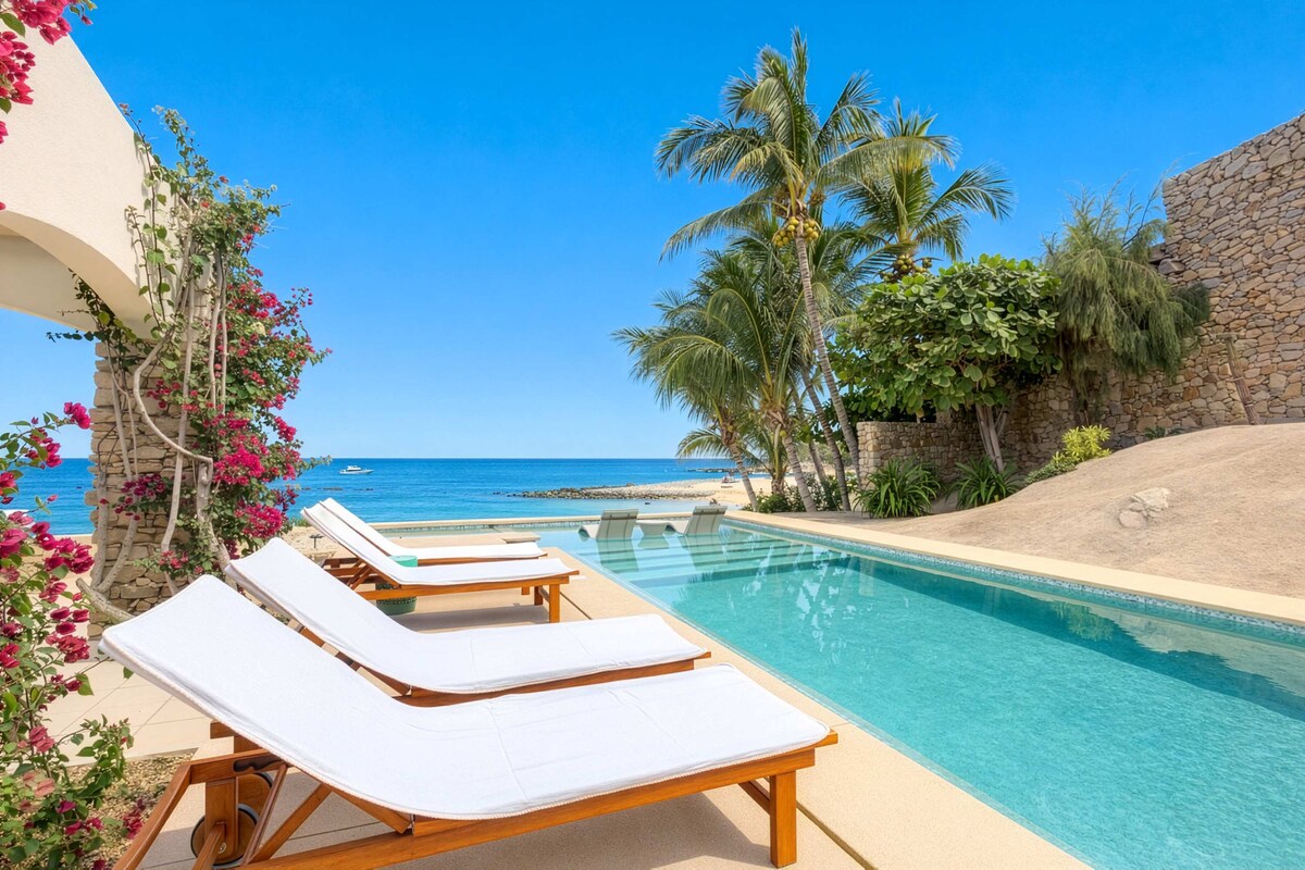 Lush poolside escape with sun loungers framed by tropical blooms and palms.