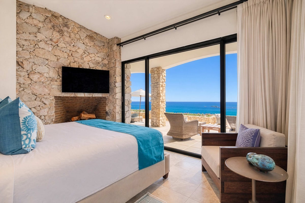 King suite with teal accents, ocean views and a luxurious en-suite bathroom.