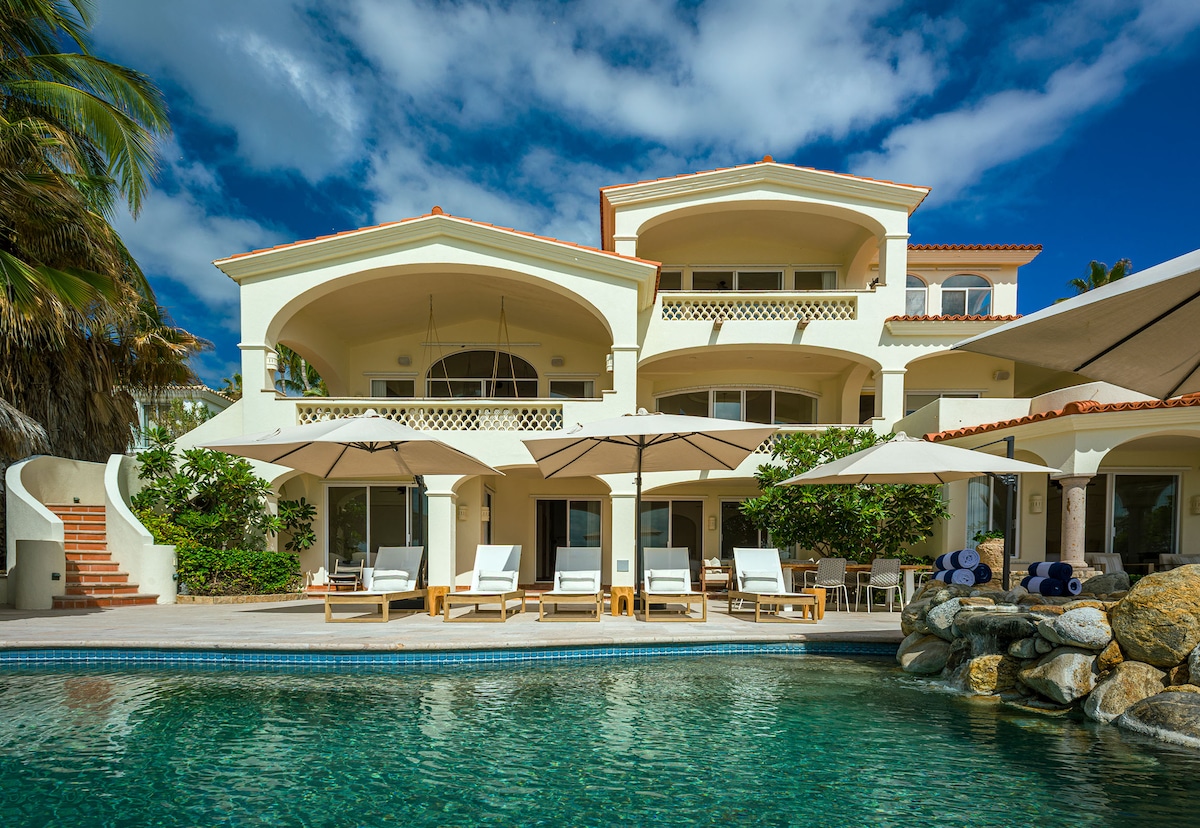 Casa Edwards Too facade with arched balconies, umbrellas and pool, Punta Bella, Los Cabos.