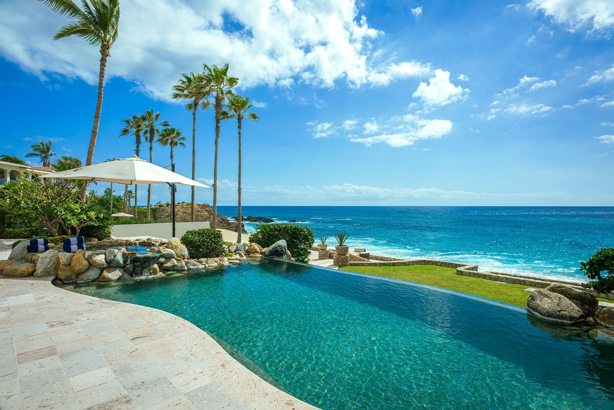 Infinity pool with a rock waterfall and ocean views at Casa Edwards Too, Punta Bella, Los Cabos.