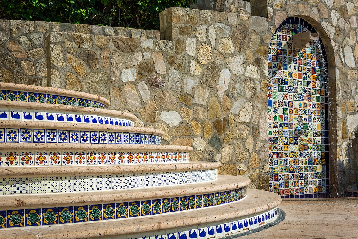 Hand-tiled talavera staircase and stone wall detail at Casa Edwards, luxury villa in Palmilla