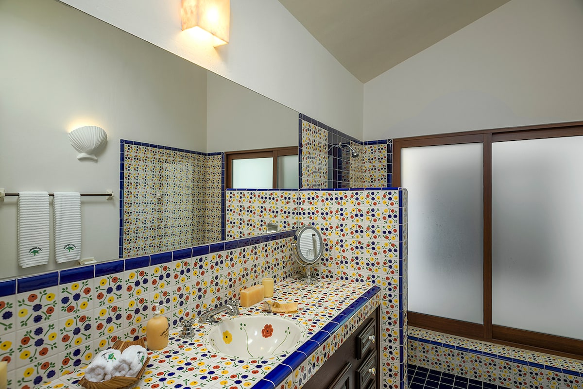 En-suite bathroom with hand-painted talavera vanity and folded towels at Casa Edwards, Palmilla