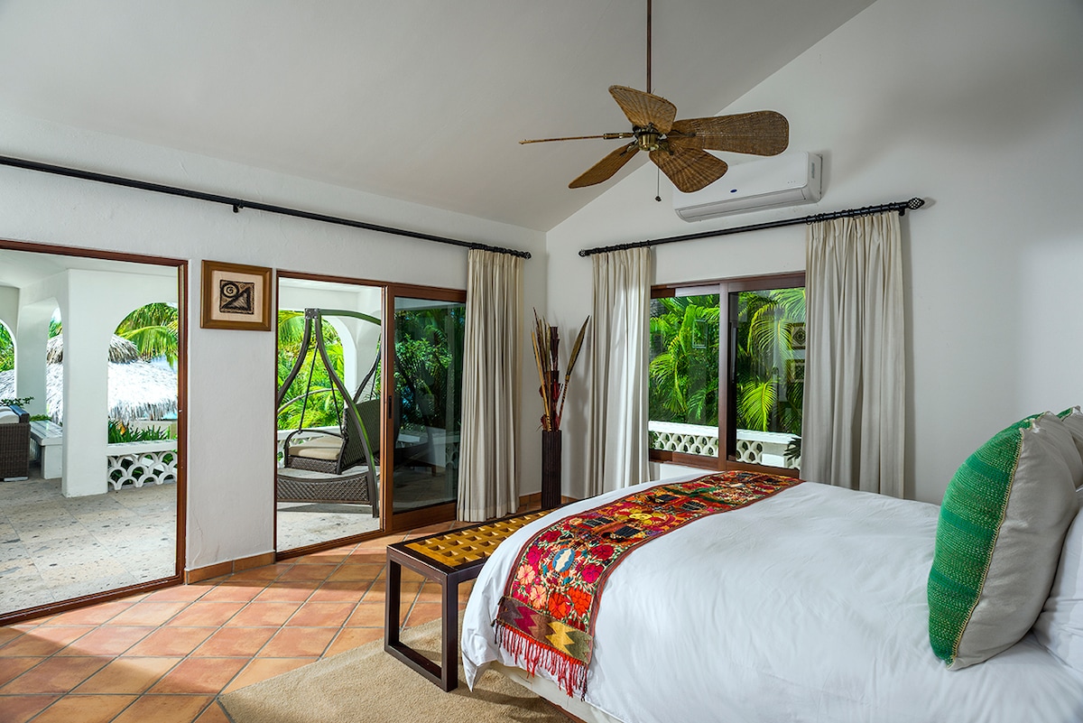En-suite bedroom with terracotta floors opening onto a private terrace at Casa Edwards, Palmilla