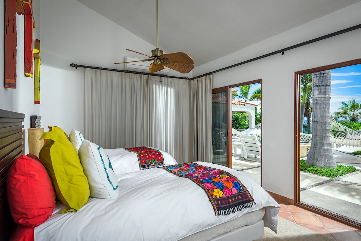 En-suite bedroom with colourful textiles overlooking the pool terrace at Casa Edwards, Palmilla, Los Cabos