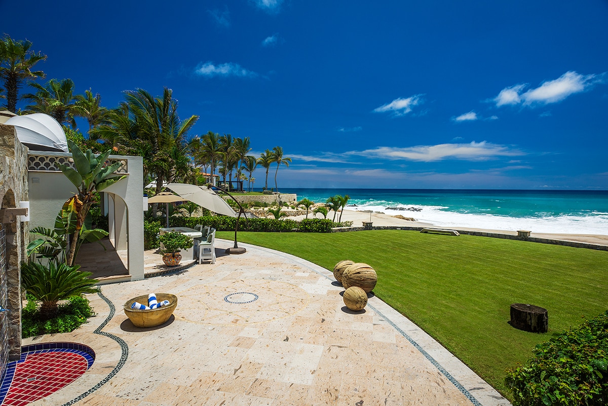 Oceanfront lawn, palapa and beach frontage at Casa Edwards, luxury villa in Palmilla, Los Cabos