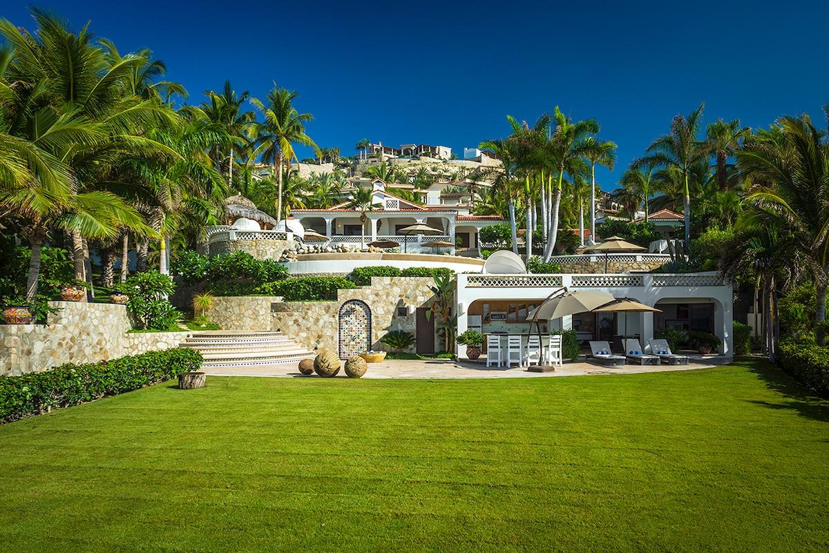 Large oceanfront lawn and the main house at Casa Edwards, beachfront luxury villa in Palmilla, Los Cabos