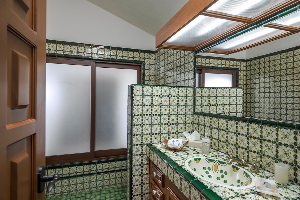 En-suite bathroom with green talavera tile vanity at Casa Edwards, luxury villa in Palmilla, Los Cabos