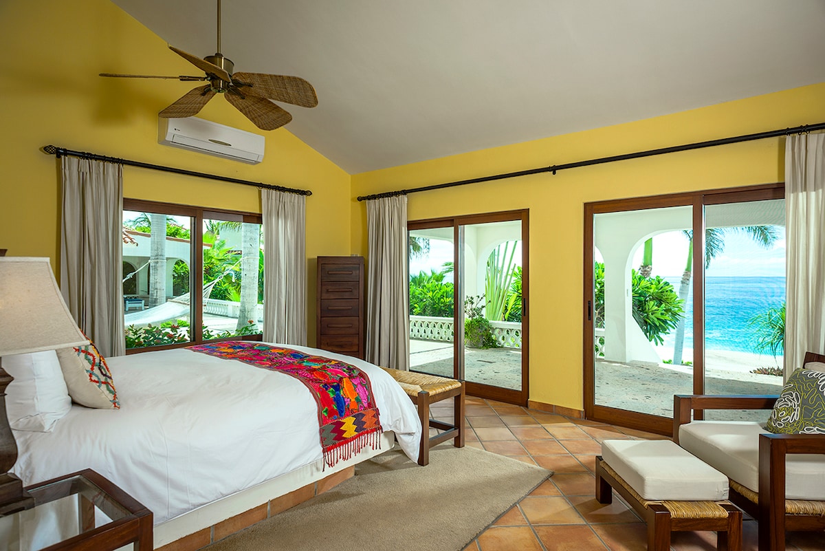 Ocean-view en-suite bedroom with king bed opening to the garden at Casa Edwards, Palmilla, Los Cabos