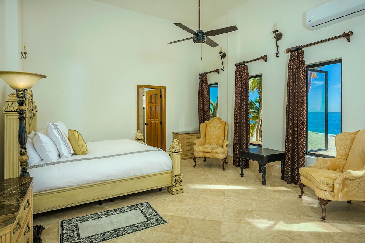 Villa Paraiso Cabo waterfront suite bedroom and chairs